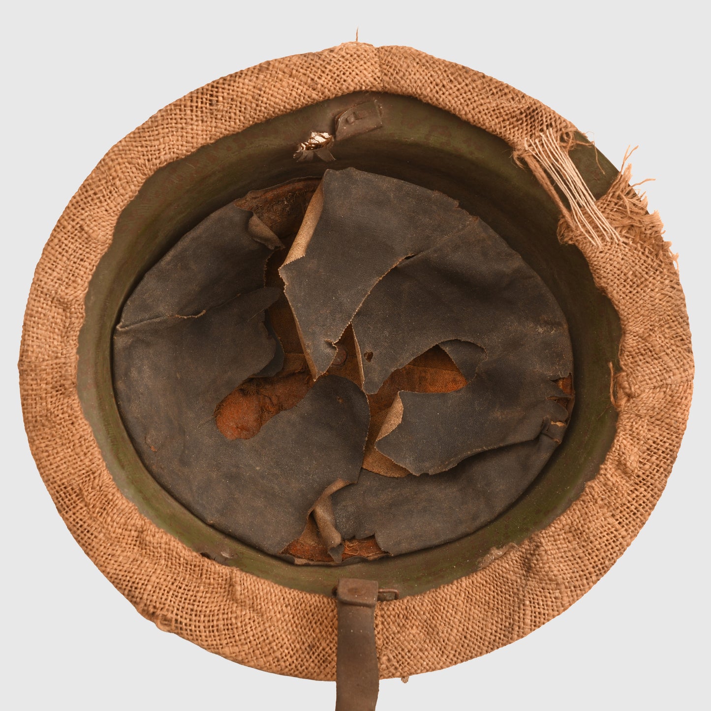 BRITISH WWI VERY FIRST PATTERN BRODIE HELMET IN GREEN WITH BATTLE DAMAGE AND FIELD COVER