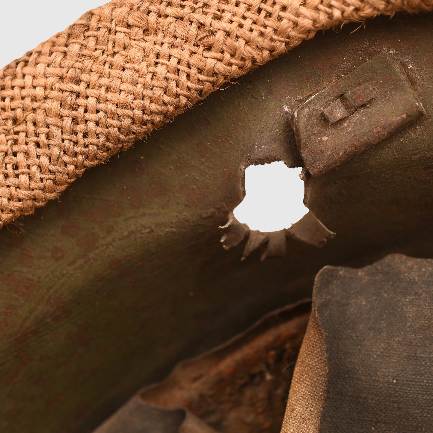 BRITISH WWI VERY FIRST PATTERN BRODIE HELMET IN GREEN WITH BATTLE DAMAGE AND FIELD COVER