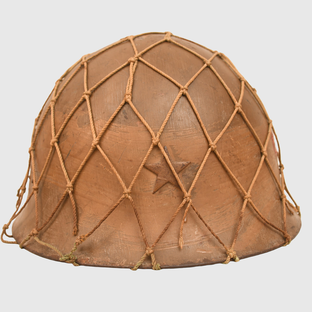JAPANESE WWII TYPE 90 COMBAT HELMET WITH CAMOUFLAGE NET, IDENTIFIED TO AN INDIVIDUAL SOLDIER