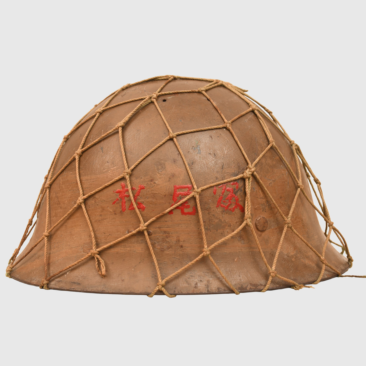 JAPANESE WWII TYPE 90 COMBAT HELMET WITH CAMOUFLAGE NET, IDENTIFIED TO AN INDIVIDUAL SOLDIER