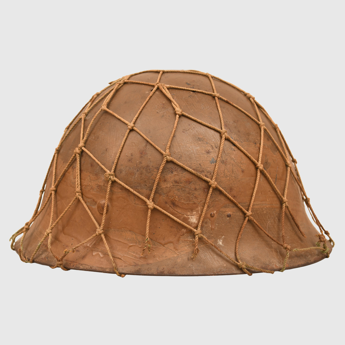 JAPANESE WWII TYPE 90 COMBAT HELMET WITH CAMOUFLAGE NET, IDENTIFIED TO AN INDIVIDUAL SOLDIER