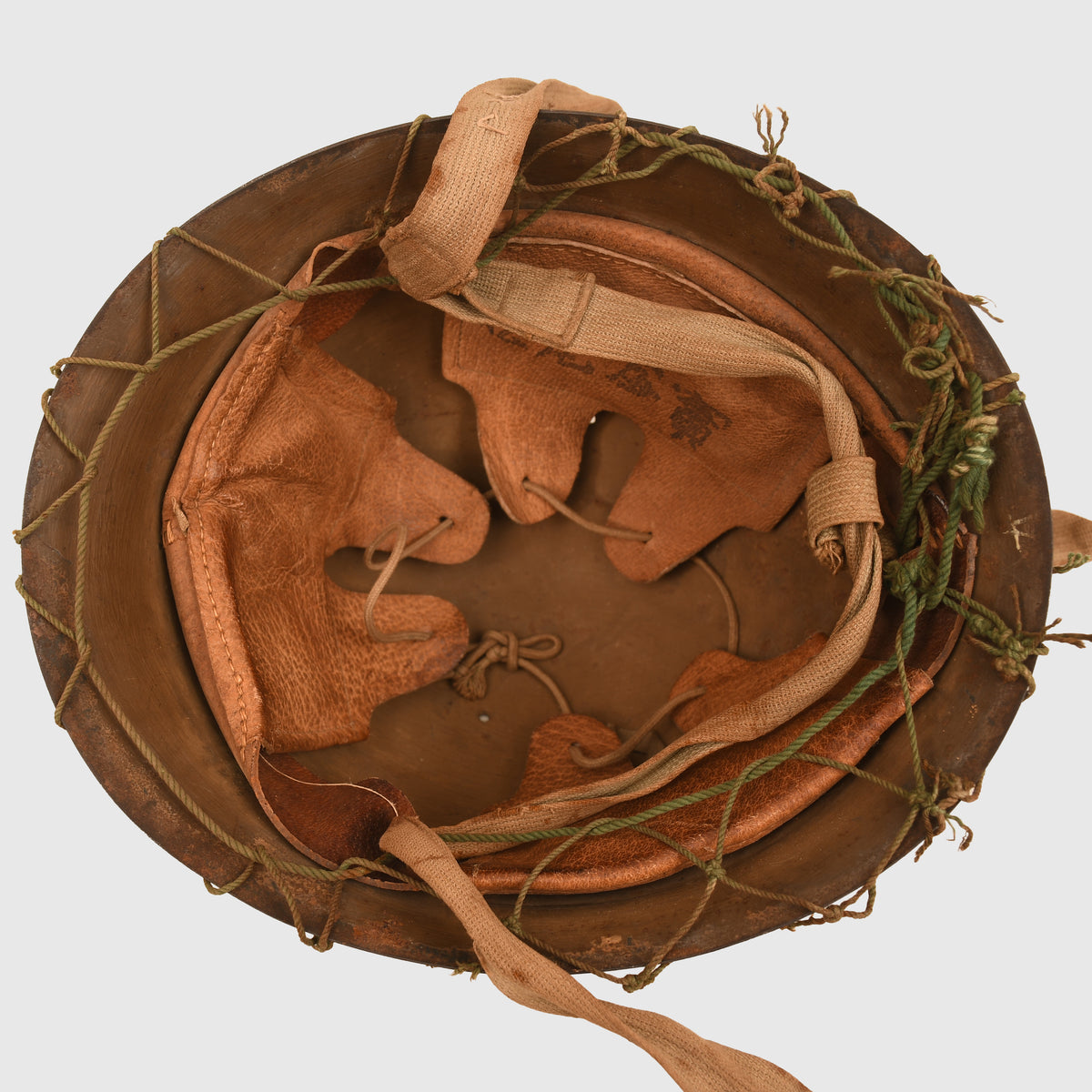 JAPANESE WWII TYPE 90 COMBAT HELMET WITH CAMOUFLAGE NET, IDENTIFIED TO AN INDIVIDUAL SOLDIER